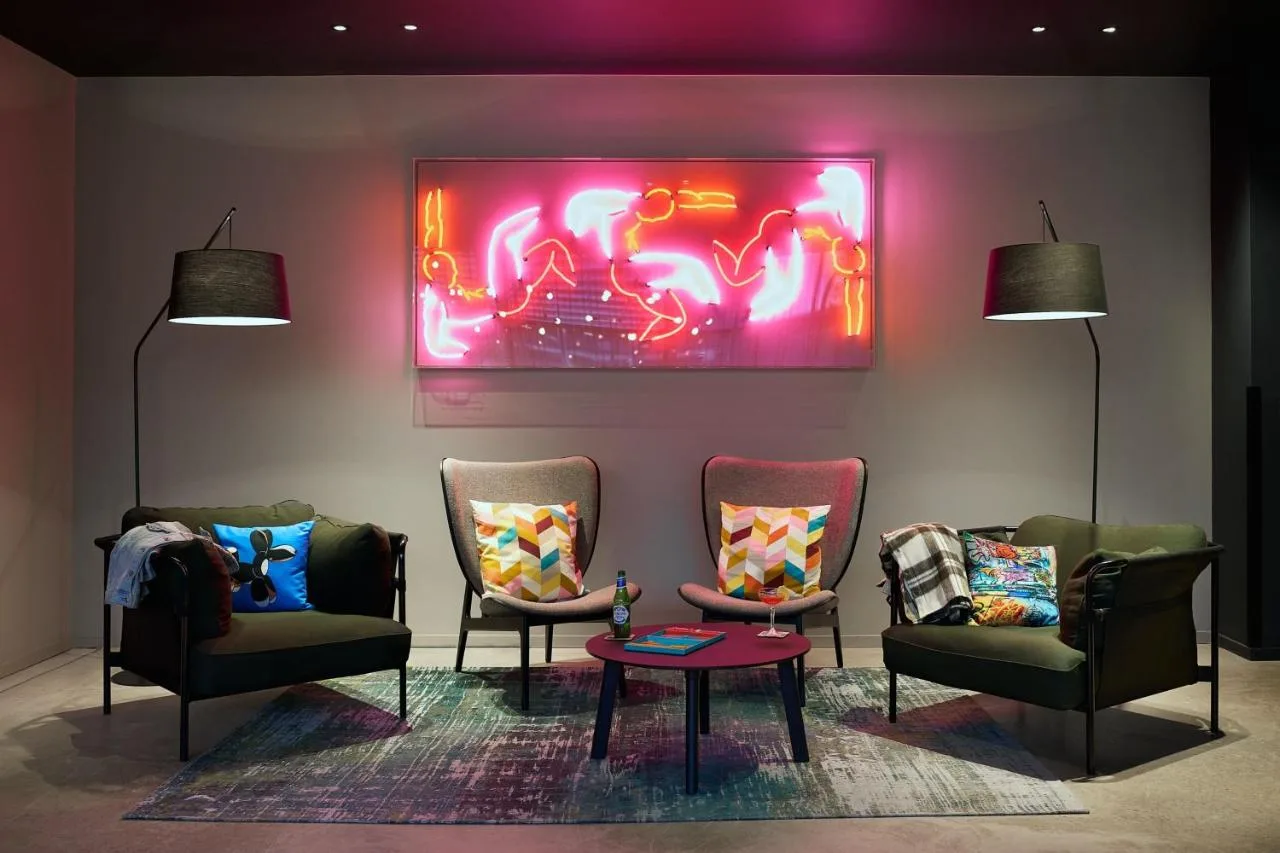 a room with two chairs and a painting on the wall at Moxy Bristol in Bristol