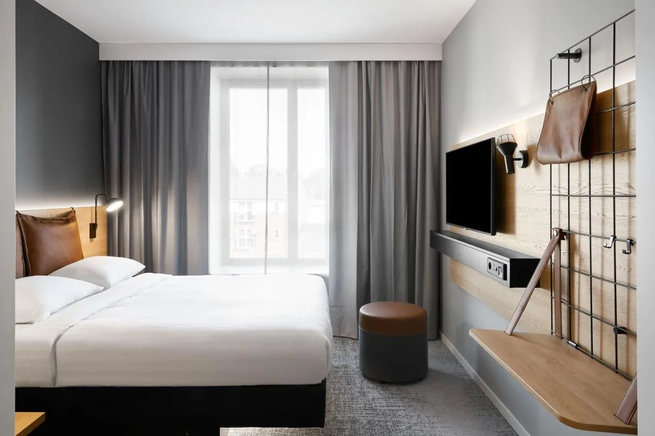 a hotel room with a bed and a tv at Moxy Bristol in Bristol